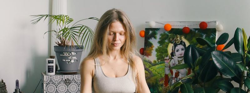 Person meditating in a lotus position in a serene environment.