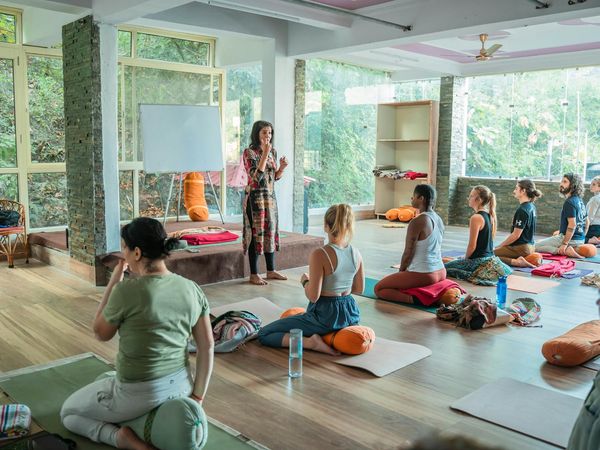 Person practicing a focused yoga pose indoors with natural light.